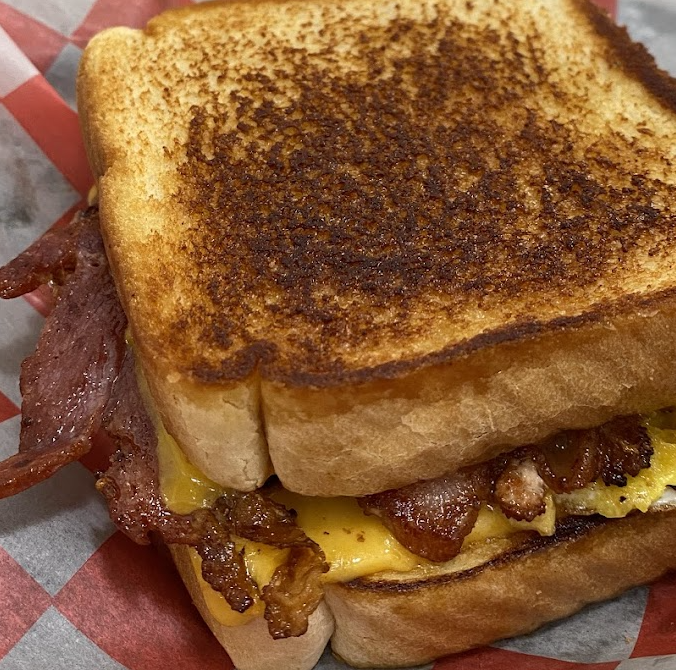 Texan Sizzle signature dishes Chorizo and Egg TacoBrisket TacoTexan Cheesesteak Sandwich